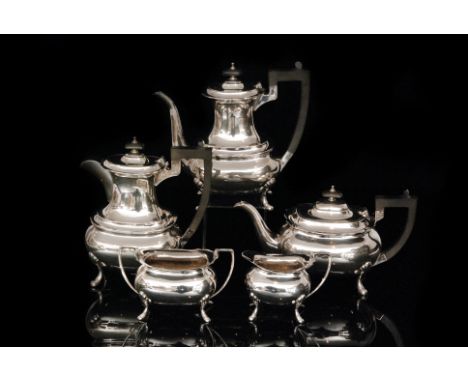 A George VI hallmarked silver five piece tea and coffee service comprising teapot, coffee pot, hot water, sugar bowl and crea