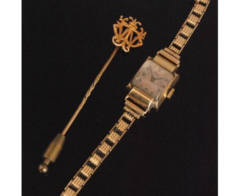 A mid 20th Century 9ct hallmarked ladies Avia wrist watch, Arabic numerals to a square dial, together with a stick pin. (2). 