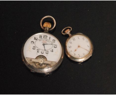 A Continental silver open faced crown wing eight day pocket watch with Arabic numerals to a white enamel dial with exposed ba