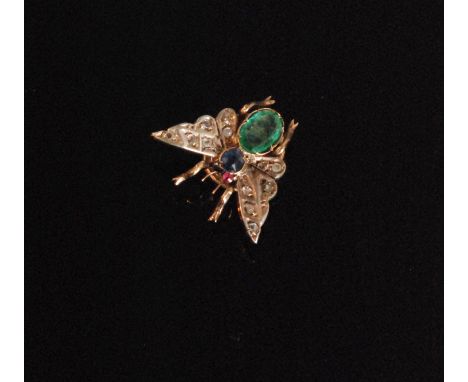 A 20th Century bug brooch or hair ornament with round cut sapphire thorax, the abdomen claw set with an oval cut emerald the 