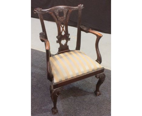 A Chippendale style mahogany carver chair with scrolled capitals and a pierced vase splat above the drop-in seat pad and cabr