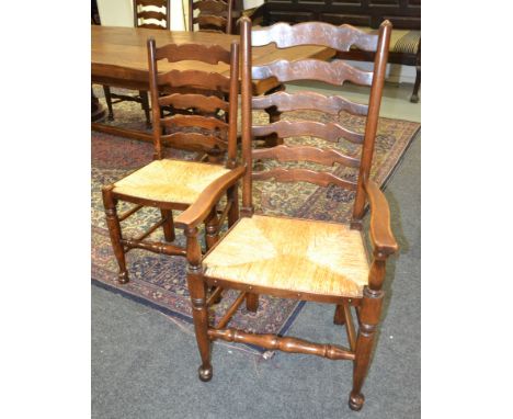 A set of eight 20th Century rush seat beech ladder back dining chairs on turned legs and stretchers (8) 