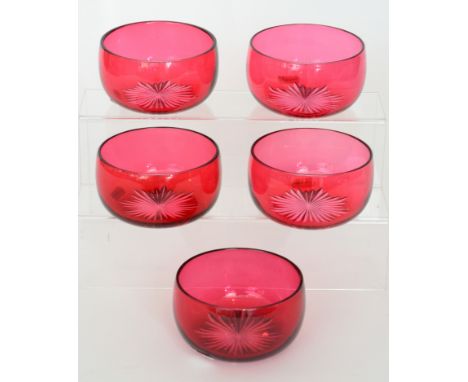 A set of five late 19th Century clear crystal finger bowls cased in ruby and flash cut to the base with a radial star, width 
