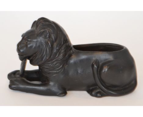 An early 20th Century Bretby model of Nelson's lion holding a shield entitled Peace, made to commemorate the end of the First