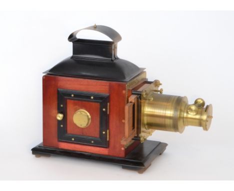 A late 19th Century brass and mahogany magic lantern, adjustable lens complete with chimney, width 52cm, restored