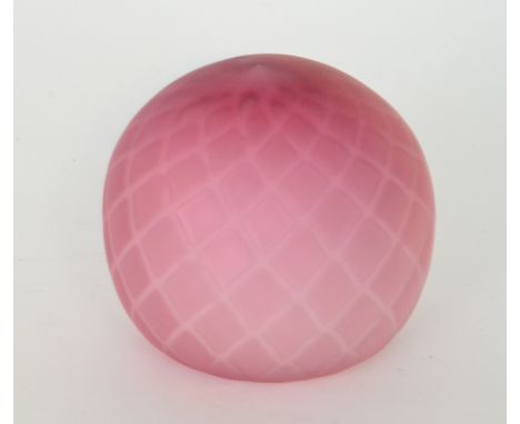 A late 19th Century Stourbridge quilted air trap satin glass paper weight of spherical form cased in a graduated ruby over op