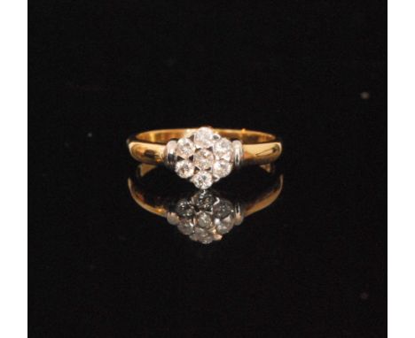 A 9ct hallmarked diamond cluster ring, seven illusion set stones to knife edged shoulders, ring size R. 