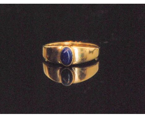 A 9ct single stone lapis lazuli ring, raised collar set oval stone to plain tapering shoulders, ring size O. 