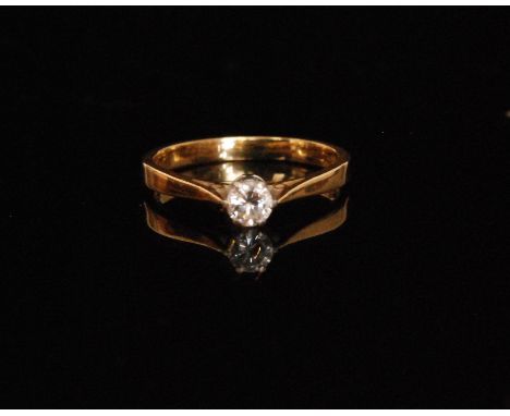 An 18ct hallmarked diamond solitaire ring, brilliant cut stone, weight approximately .30ct, claw set to knife edged shoulders