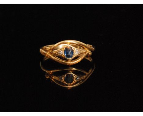 A modern 18ct sapphire and diamond three stone ring, central sapphire flanked by a diamond to either side all within pierced 