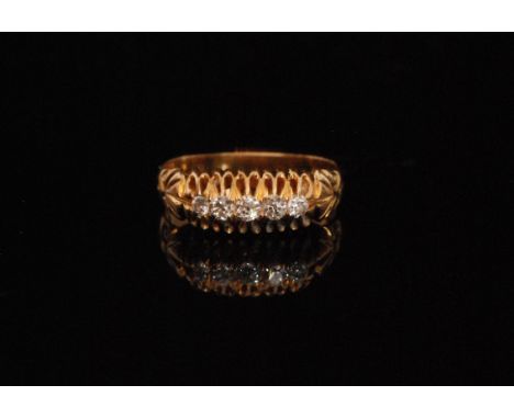 An early 20th Century 9ct diamond five stone boat shaped ring, claw set stones to scroll decorated shoulders, ring size N. 