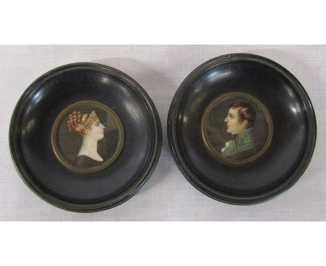 Reproduction portrait miniatures of a young man and woman in a black lacquered circular frames, both signed, D 9.5 cm includi
