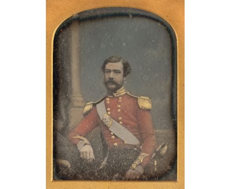 * Quarter-plate daguerreotype of a British officer by Antoine Claudet, c.1851, half-length and seated, hand-coloured scarlet 