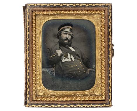 * Ninth-plate ambrotype of a British naval rating, c.1858, half-length and seated, wearing a group of 4 medals including a Ch