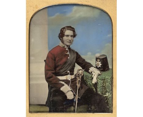 * Quarter-plate ambrotype of a Captain of the Staffordshire Militia, c.1860, three-quarter length and seated, with a shako on