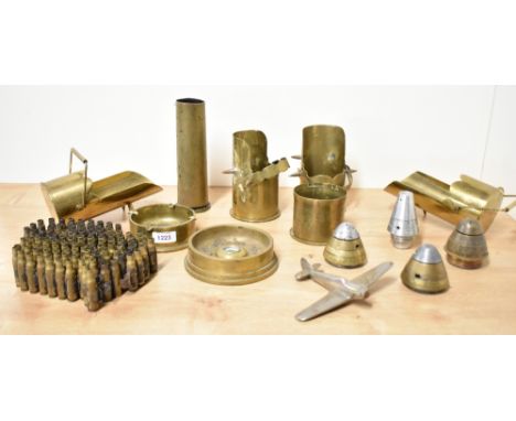 A selection of mixed World War I and II adapted brass trench art shell cases, ashtrays, scuttles, ordinance timer fuses, engr