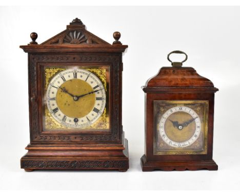 An Edwardian oak cased mantel clock in an architectural-style case, the brass dial with silvered chapter ring set with Roman 