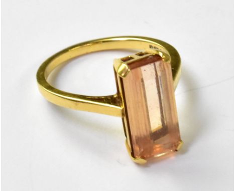 An 18ct yellow gold ladies' dress ring with a large emerald cut peach tourmaline, size P1/2, approx 4.8g. CONDITION REPORT Ap