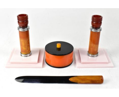 A small collection of Art Deco style items, a pair of candlesticks, amber and toffee ground with white metal stand and collar