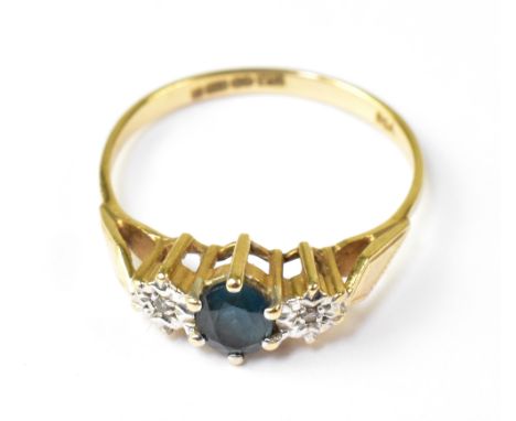 A 9ct gold dress ring, with central claw set blue stone, possibly topaz, flanked by two illusion set diamond chips, size Q, a