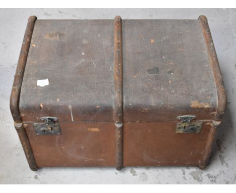 A vintage canvas covered dome-topped wooden bound travelling trunk, approx 45 x 69 x 48cm, containing a 1930s bevelled glass 