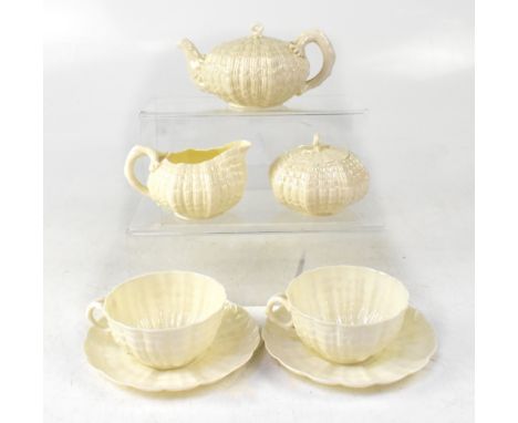 BELLEEK; a First Period 'Tridacna' seven-piece white tea set, with twisted branch handles and knops and shell-shaped body, bl