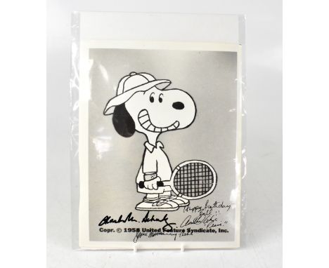 SNOOPY; a photograph of Snoopy playing tennis, inscribed 'Happy birthday Bill', bearing the signatures of Charles Schulz and 