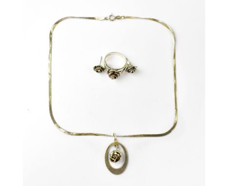 A sterling silver rose form jewellery suite comprising a necklace, ring and earrings (3). 