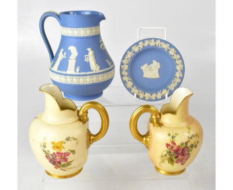 Two Royal Worcester blush ivory jugs, both with similar floral decoration, gilt handles and shape, each marked with a green a