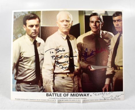 BATTLE OF MIDWAY; a promotional photograph bearing the signatures of Henry Fonda, Charlton Heston and James Coburn, 20 x 25.5