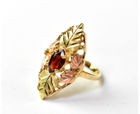 A 9ct yellow and rose gold ladies' dress ring, marquise shape with engraved leaf design and central marquise garnet, size K, 