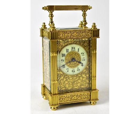 A French brass cased carriage clock, the ivorine dial set with Arabic numerals, foliate panel with pierced panels to the side