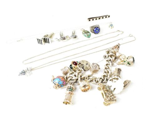 A silver charm bracelet set with mainly silver plated charms, some hallmarked, with a hallmarked silver heart-shaped padlock,