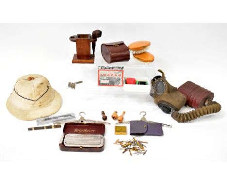 A collectors' lot to include an 'Avon' gas mask, a vintage safari hat, shaving ephemera, a pipe rack, a razor, etc. 
