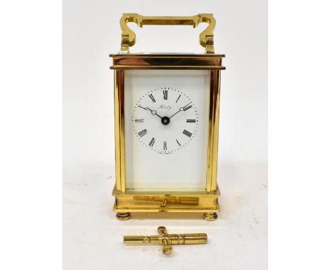 A brass cased English carriage clock by Henley, the painted dial set with Roman numerals, movement stamped 'Henley England', 