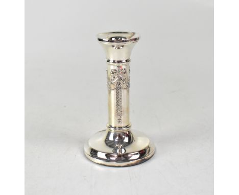 An Elizabeth II hallmarked silver single column candlestick with ribbon and swag repoussé decoration to stepped circular base