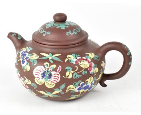 A late 19th/early 20th century Yixing enamelled teapot, the brown clay body decorated with enamelled flowers and insects, hei