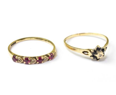 A 9ct gold diamond and sapphire floral cluster ring with a tiny central diamond, within a ring of six small sapphires, size P