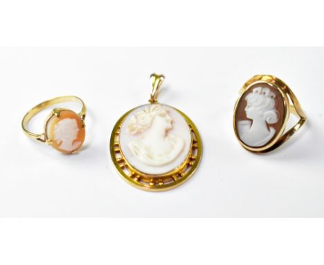 A 9ct yellow gold oval cameo pendant and two 9ct yellow gold cameo dress rings, one in deep oval mount, size K, one smaller e