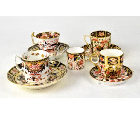 A group of late 18th/early 19th century coffee cans and saucers, each decorated in a form of Imari pattern, to include a Dave