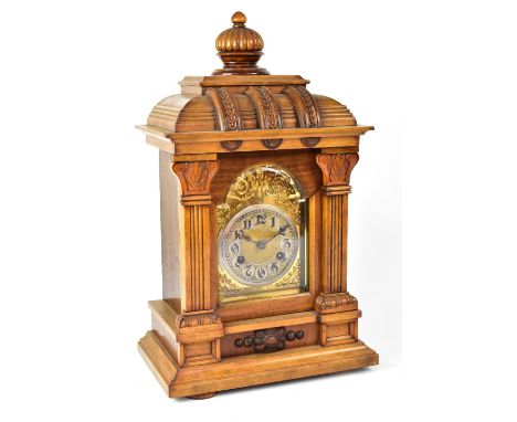 JUNGHANS; a late 19th century walnut eight day mantel clock, the dial set with Arabic numerals on silvered chapter ring and b