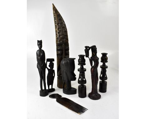 Various carved hardwood African tourist items, to include a pair of candlesticks, ring turned with tribal head to centre, hei