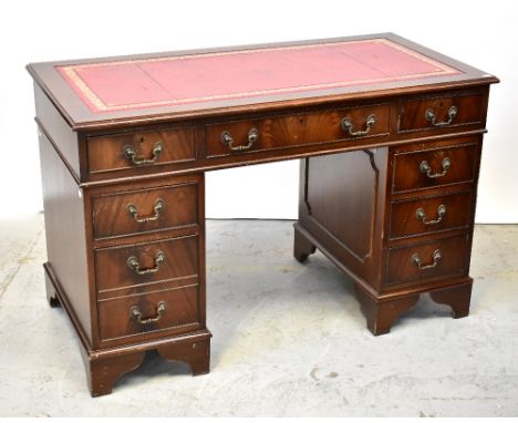 A reproduction mahogany nine-drawer twin pedestal desk, with inset gilt-tooled red leather panel, 78 x 122 x 61cm. Footnote: 