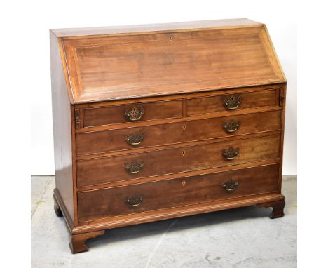 A George III mahogany line inlaid and crossbanded bureau, the fall front enclosing a fitted interior of pigeonholes, drawers 