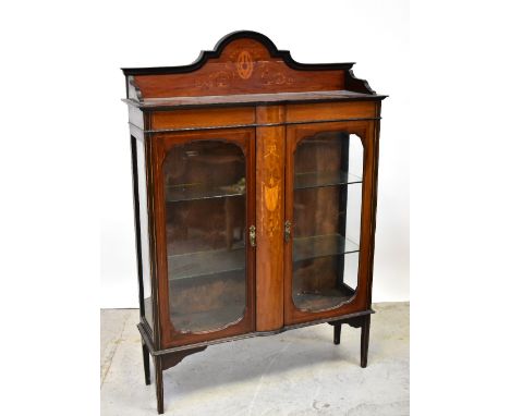 An Edwardian inlaid mahogany display cabinet with galleried arched inlaid top above a pair of glazed cupboard doors, divided 