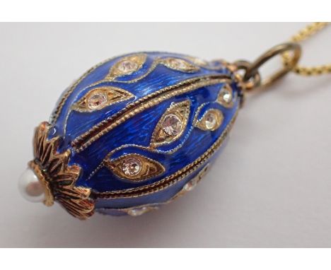 Gold plated 925 silver chain suspending blue enamel and white stone egg 