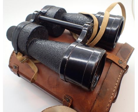 Pair of Naval Defence binoculars dated 1944 with military arrow graticules and leather case