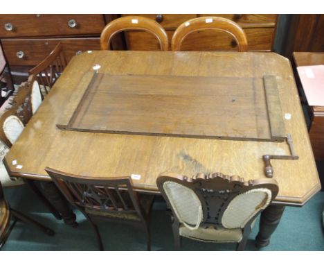 An oak extending dining table and two balloon back chairs (3) Condition Report:water stains on top, well used item with assoc