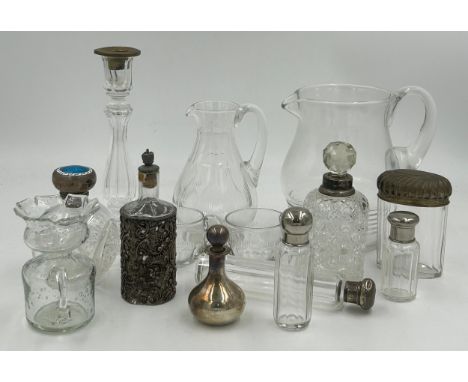 A collection of glass to include candlestick 22cm, 2 x jugs and 2 x small cups, 3 x perfume bottles with hallmarked silver st