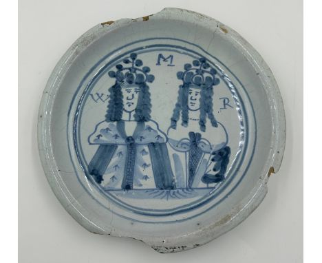 A London delftware plate of William and Mary head and shoulder portraits inscribed 'W M R', measuring 22cm.